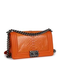 This medium Chanel Boy Bag is in orange python leather with aged ruthenium hardware, a front flap with Le Boy CC push closure, one slip pocket on back wall, and aged ruthenium chain link and orange leather shoulder strap.The interior is lined in orange leather and has one open slit pocket on the rear wall.Collection: 19-series (2014)Origin: FranceCondition: Pre-owned; Excellent to Mint - This bag retains its shape. The exterior leather has some minor light wear around the corners of the bag. There's no plastic on the hardware and no signs of scratches. The interior leather is clean with signs of wear and the date stamp sticker is still intact.Accompanied by: Chanel box, Chanel dustbag and COA CardMeasurements: 9.5" width x 6" height x 3.5" depth; 22" strap drop (12" doubled) Chanel 2014, Chanel Box, Small Boy, Chanel Shoulder Bag, Orange Bag, Orange Leather, Chanel Boy, Chanel Boy Bag, Flap Bag