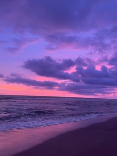 a purple sky over the ocean at sunset