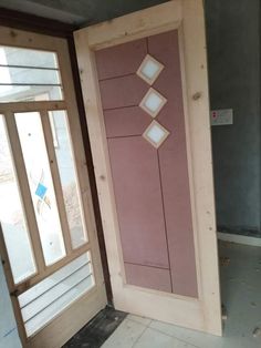 a pink door with diamond cutouts on the front and side panels is being installed