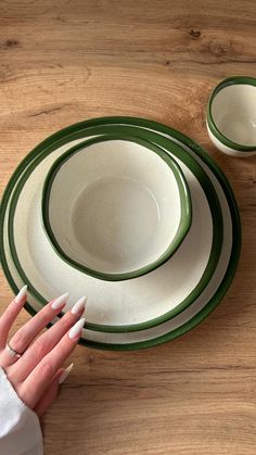 a woman's hand on the edge of two plates