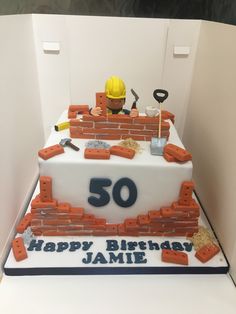 a birthday cake made to look like a brick wall with the number 50 on it