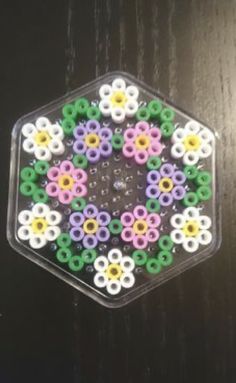 a hexagonal object made out of plastic beads