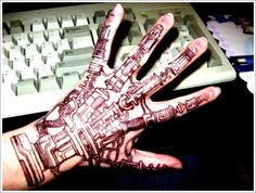 a person's hand with a drawing on it next to a keyboard and mouse