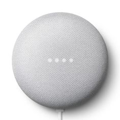 the google home speaker is plugged into an ipod charger, with three small white dots on it