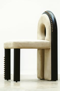 a white bench sitting next to a black and white chair