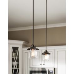 three lights hanging from a kitchen ceiling