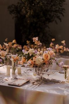 a table with flowers and candles on it