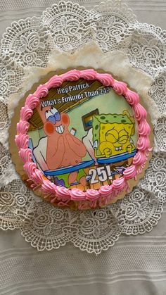 a spongebob themed birthday cake on a lace doily