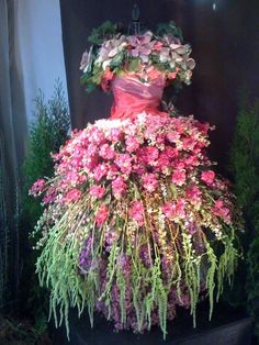 a dress made out of flowers sitting on top of a planter