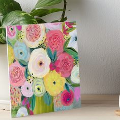 a painting of flowers on a table next to a potted plant art board print