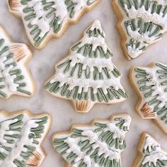 christmas cookies decorated with green and white icing are arranged in the shape of trees