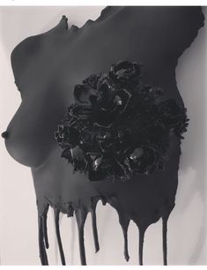 a black and white photo with dripping paint on the bottom half of it, depicting flowers