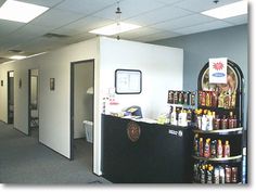 the inside of an office building with several shelves on each side and various items on the wall