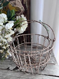 a wire basket with white flowers in it