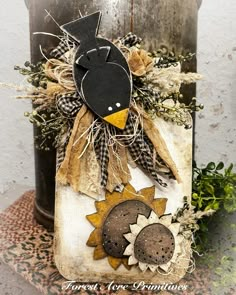 a black and white bird sitting on top of a piece of wood with sunflowers