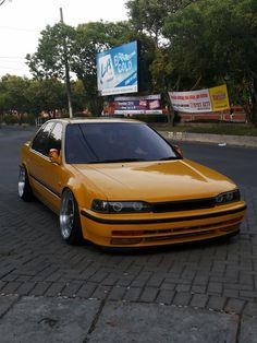 a yellow car is parked on the side of the road