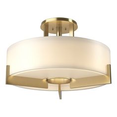 a semi flush light fixture with a white shade on the bottom and gold trimming