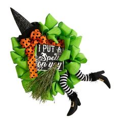 a green wreath with black and white striped stockings, witch hat and polka dot socks