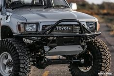 the front end of a silver toyota pickup truck