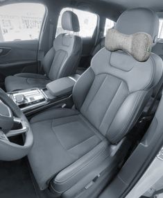 the interior of a car with grey leather seats