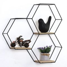 three hexagonal shelving shelves with various items on them, including a motorcycle