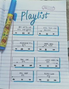 a playlist is shown on top of a notebook with a pen next to it