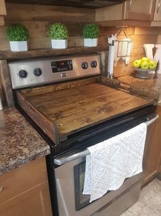 a stove top oven sitting inside of a kitchen next to a counter with two lemons on it