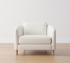 a white chair sitting on top of a hard wood floor next to a white wall