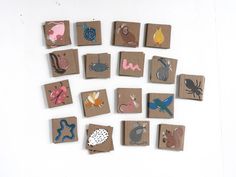 several small pieces of paper with different designs on them are arranged in the shape of animals