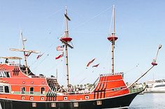 a red and black boat in the water