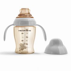 the baby bottle is next to an infant cup