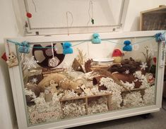 a display case filled with stuffed animals and snowflakes on top of it's sides