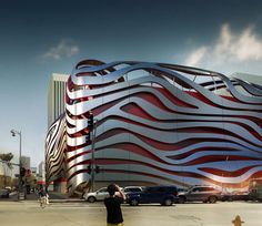 a man is standing in front of a building with red and white stripes on it