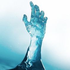 a hand that is in some water with it's fingers up to the sky