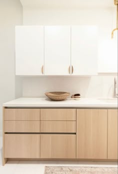 a bowl on top of a counter in a room with white walls and flooring