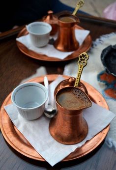 two cups and saucers are sitting on a plate