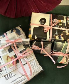 two boxes with pink ribbons tied around them