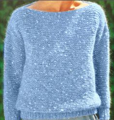 a woman wearing a blue sweater and jeans