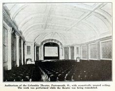 an old black and white photo of the inside of a theatre with rows of seats