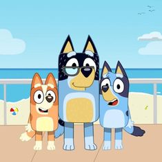 three cartoon dogs standing next to each other on a beach with the ocean in the background