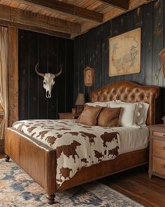 a large bed sitting in a bedroom next to a cow head mounted on the wall