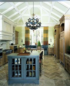 a large kitchen with an island in the middle and lots of cabinets on both sides