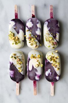 six popsicles with different toppings on them