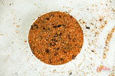 a white bowl filled with spices on top of a table