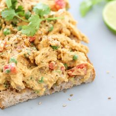 an open face sandwich topped with guacamole and cilantro