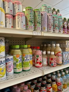 many different kinds of juices are on shelves in a store or convenience section for sale