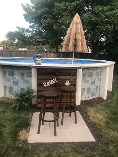 an above ground swimming pool with chairs and tables