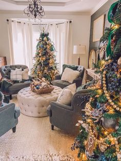 a living room filled with lots of furniture and a christmas tree in the middle of the room