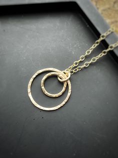 A beautiful solid gold necklace, 16 inches, 18 or 20 inches long. A simple and stylish 9ct gold necklace made by me! All the gold jewellery I make is made from 100% solid gold. The smallest hoop measures 9-10mm, the largest hoop measures 14-16mm. Solid gold interlocking circle necklace, a handmade hammered textured 9ct solid gold hoop, round modern gold chain necklace. * FREE POSTAGE TO THE UK* All measurements are approximate.  Every pair of earrings and cufflinks are individually made so are n Interlocking Circle Necklace, Solid Gold Necklace, Circle Necklace, Gold Hoop, Buy Handmade, Gold Chain Necklace, Recycled Gold, Circle Pendant, Gold Chains