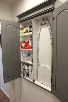 an open cabinet in the corner of a room